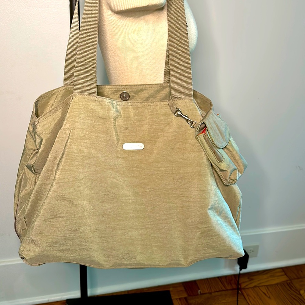 Baggallini large travel bag. Middle zipper, snap sides. Tan w/ orange interior.